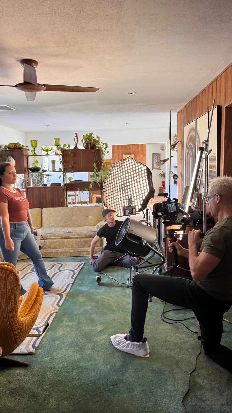 Behind the scenes: people, a camera and lighting equipment during a production.